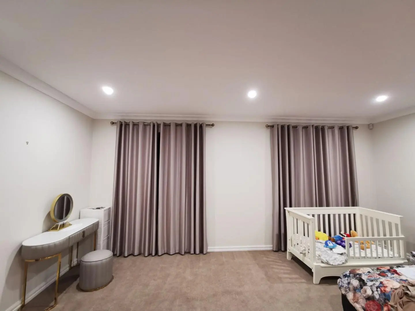 Elegant bedroom interior with beautiful curtains and a cozy crib.