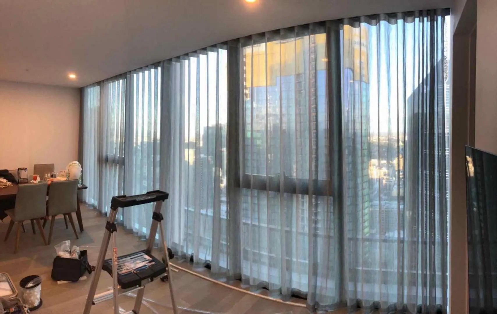 Sheer curtains are installed in a modern apartment, offering light control and stylish appeal.
