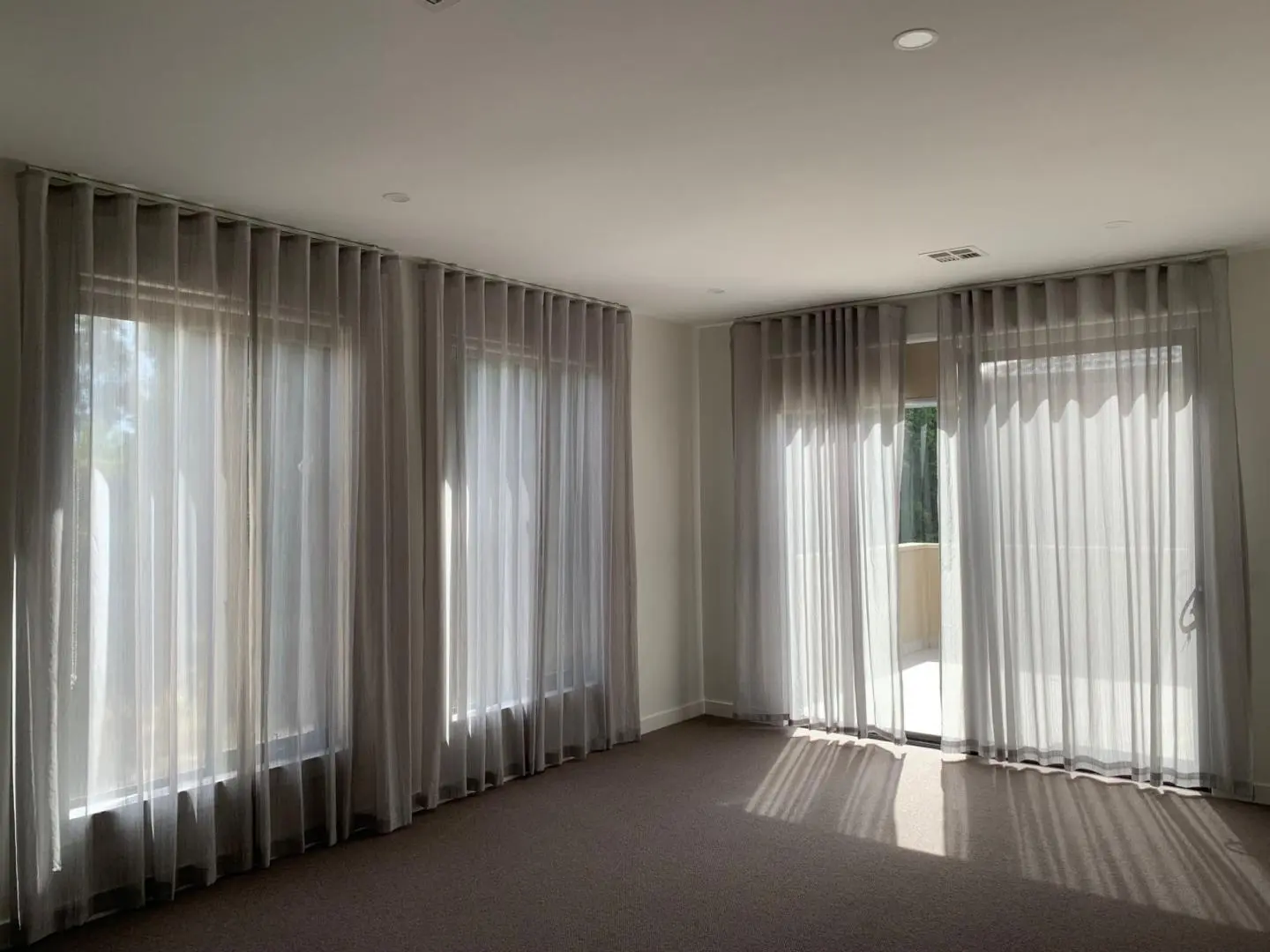 Sheer curtains in a bright room provide privacy and filter sunlight beautifully.