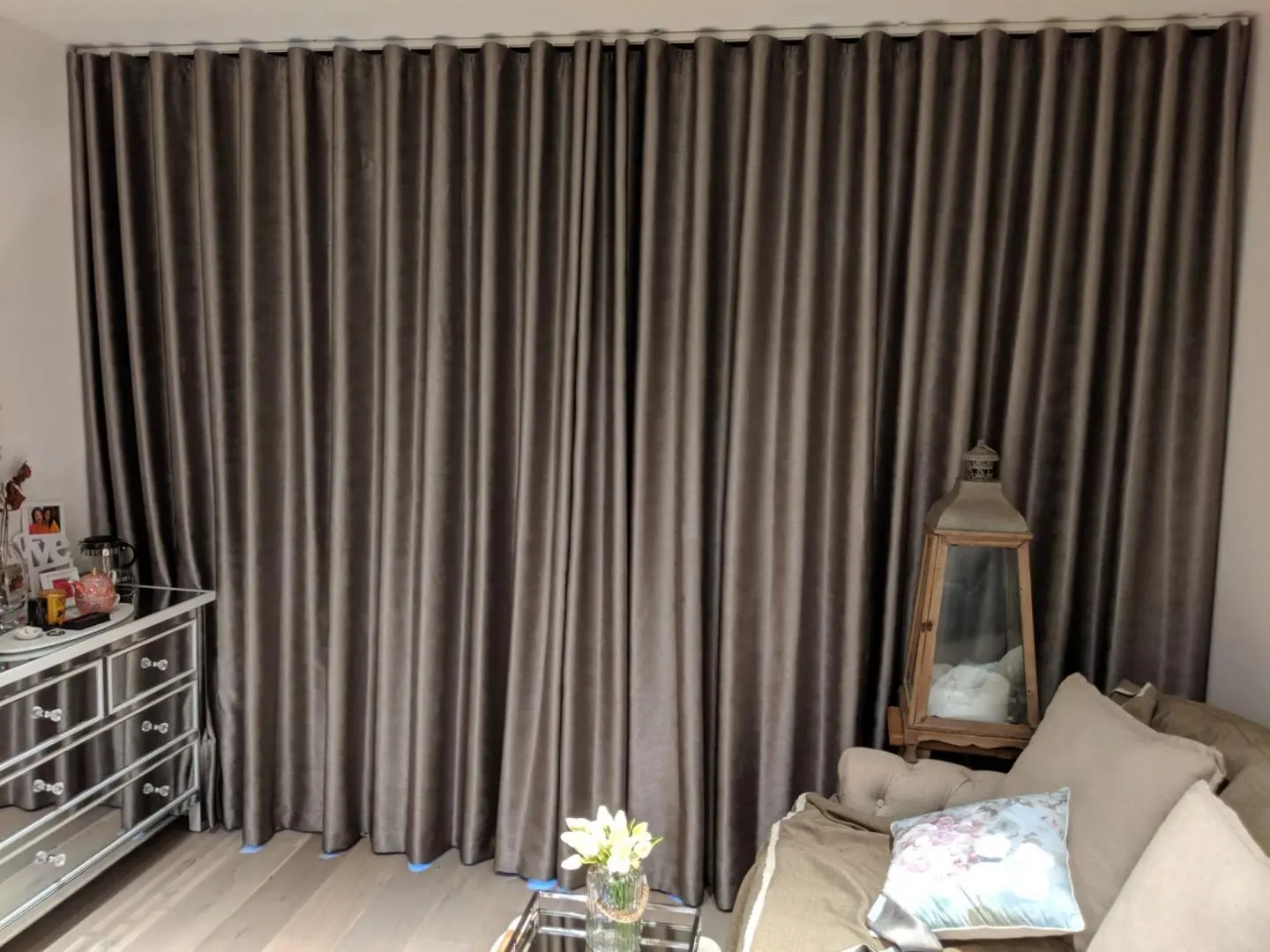 Gray curtains enhance the living rooms aesthetic.