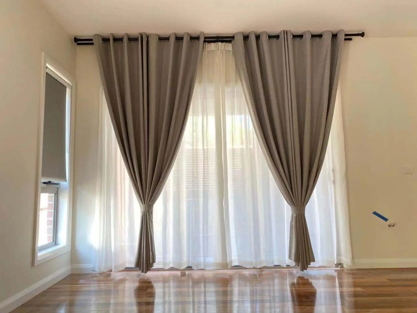 Elegant gray curtains frame a bright window in a modern living room.