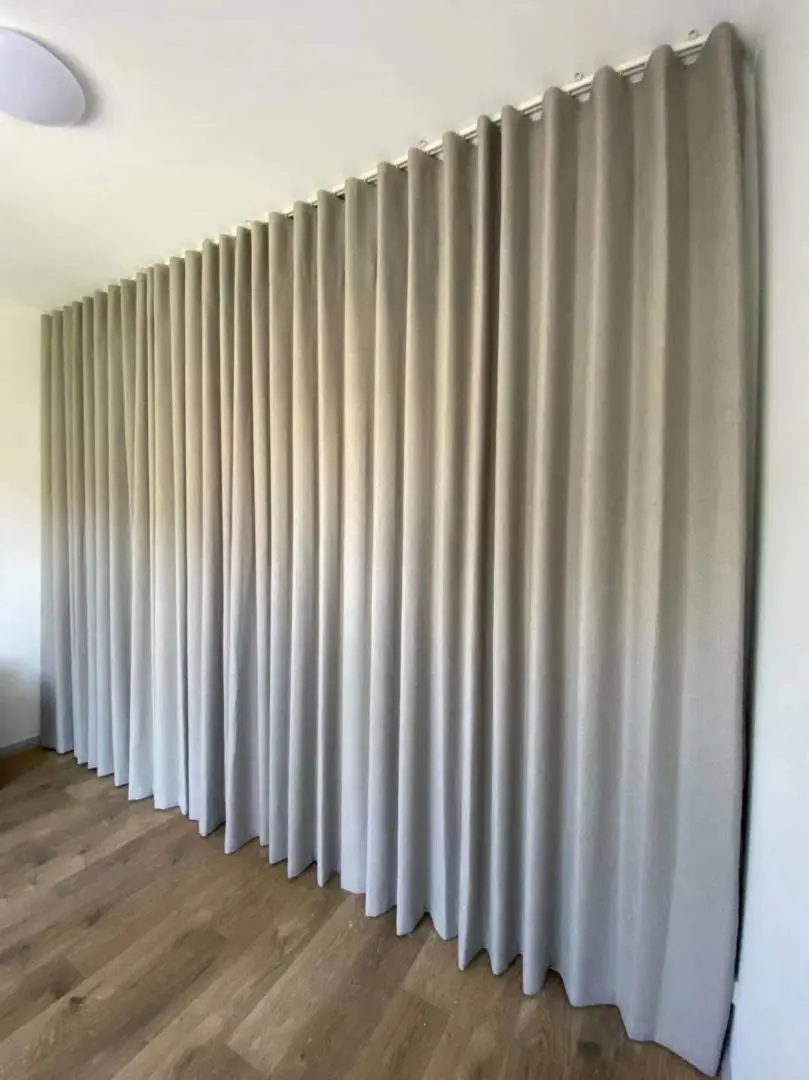 Gray curtains hang in a room, adding privacy and style.