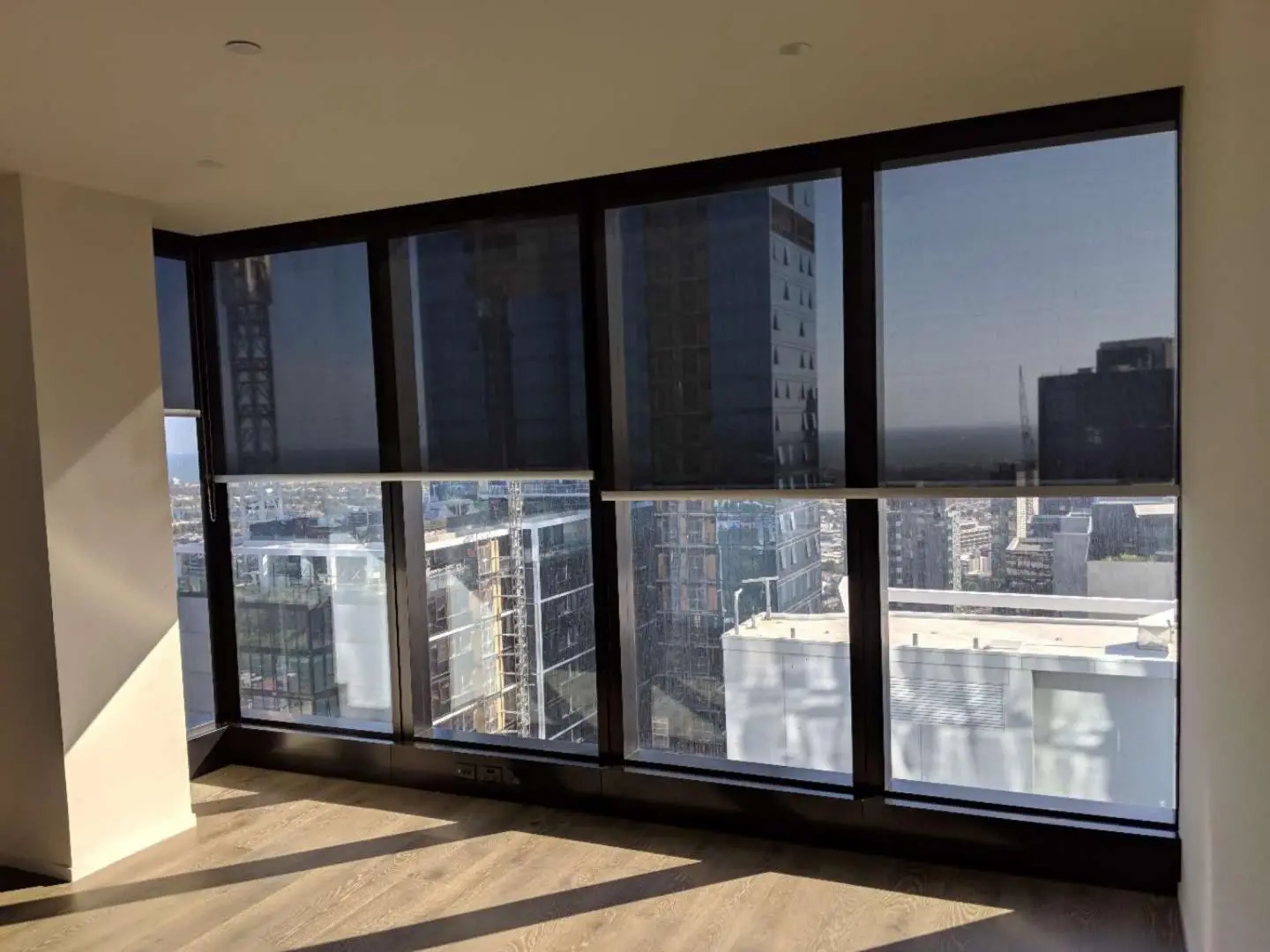 Modern city apartment with window shades for privacy and light control.