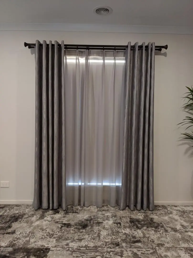 Elegant gray curtains enhance a living room with privacy and style.