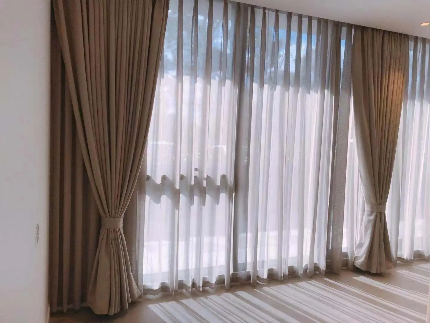 Sunlit living room with elegant curtains for privacy and style.