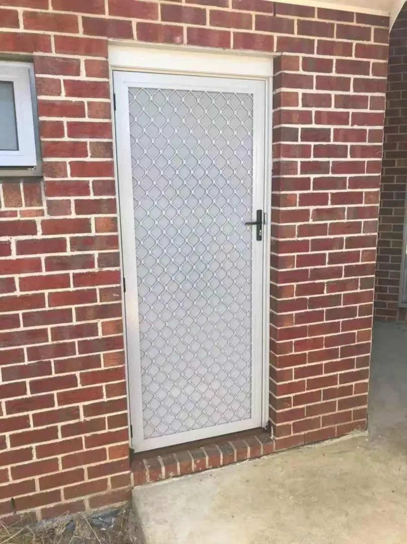 Silver security door set into a brick wall.